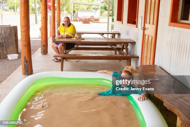Jasmin Kew relaxes in a blow up pool full of muddy tap water from the Darling River in 47 degree heat outside of Shindy's Inn on January 17, 2019 in...