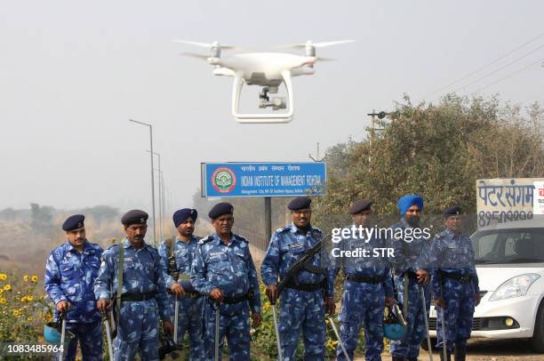 Police stand guard with a hovering drone near a jail where Indian guru and convicted murderer Gurmeet Ram Rahim Singh was being held, in anticipation...