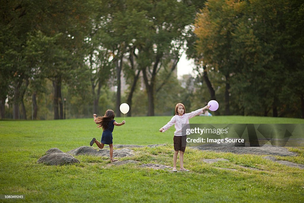Girls at birthday party holding balloons