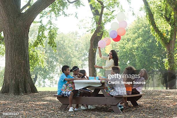 outdoor birthday party with balloons - picnic table park stock pictures, royalty-free photos & images