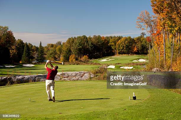 senior caucaisan golfer on the tee in fall - golf short iron stock pictures, royalty-free photos & images