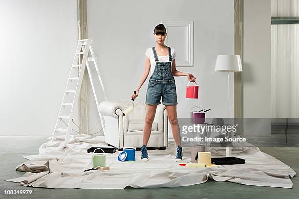 young woman decorating room - woman diy stock pictures, royalty-free photos & images
