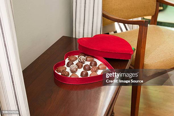 chocolates in heart shaped box - box of chocolates stock pictures, royalty-free photos & images