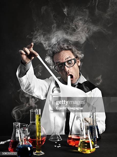 mad scientist playing with gloves - mad scientist stock pictures, royalty-free photos & images