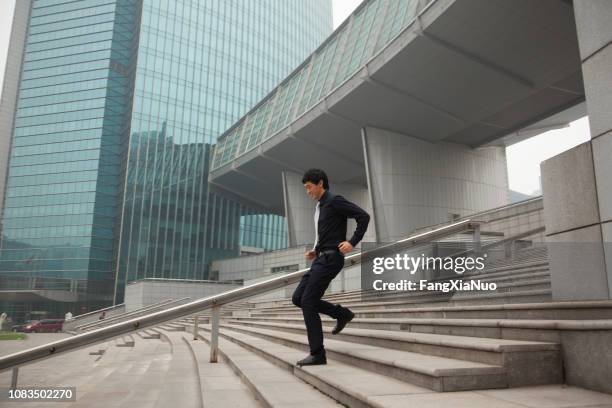 chinese businessman on city steps - beijing people stock pictures, royalty-free photos & images