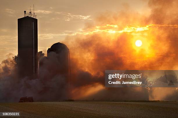 barn fire in the light of sunset - heat haze stock pictures, royalty-free photos & images