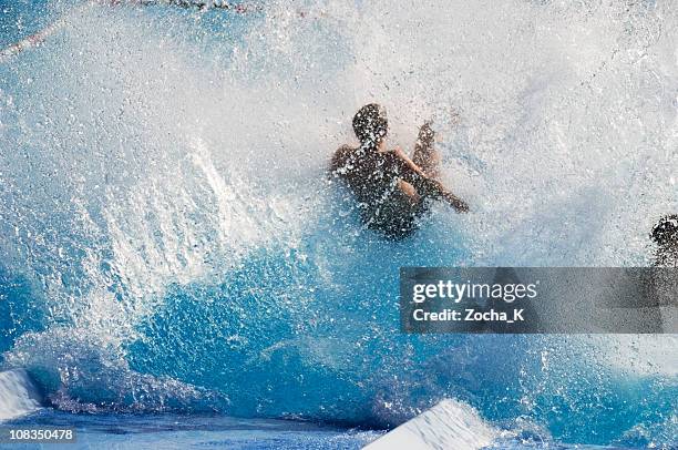 boy making splash in pool - water park stock pictures, royalty-free photos & images