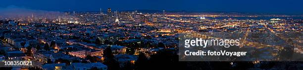 san francisco glittering lights downtown illuminated blue dusk panorama california - mission district stock pictures, royalty-free photos & images