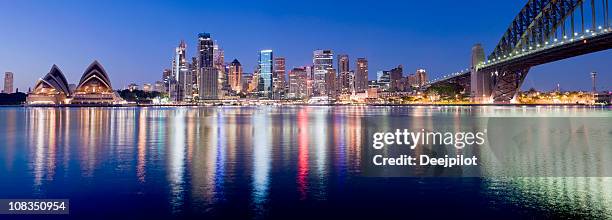 sydney skyline lights make vertical reflections in water - sydney skyline stock pictures, royalty-free photos & images