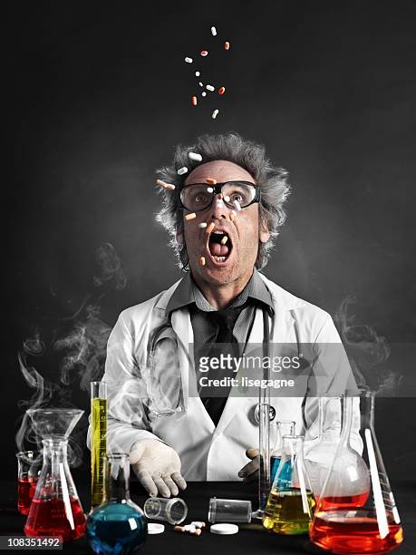 mad professor eating pills - mad scientist stock pictures, royalty-free photos & images
