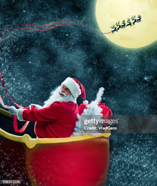 santa claus in his deer sled near the moon - sleigh stock pictures, royalty-free photos & images
