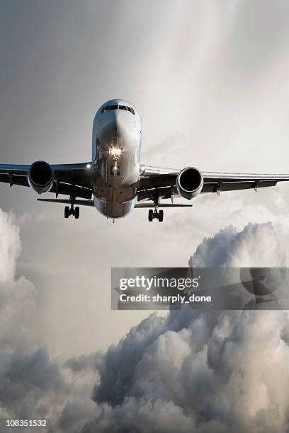 jet airplane landing in storm - airplane lights stock pictures, royalty-free photos & images