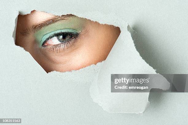 looking out through hole - tear face stock pictures, royalty-free photos & images