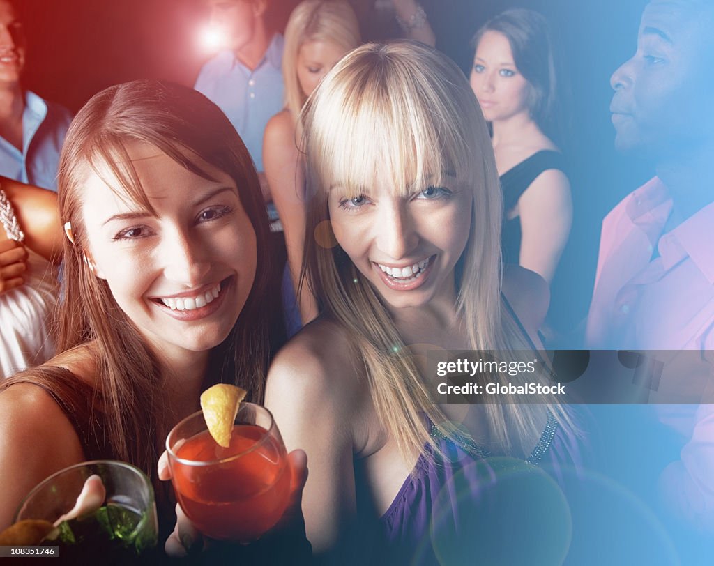 Young friends having cocktail and enjoying at nightclub
