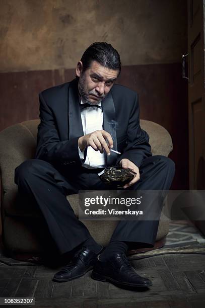 portrait of middle years gentleman - cigarette smoking stockfoto's en -beelden