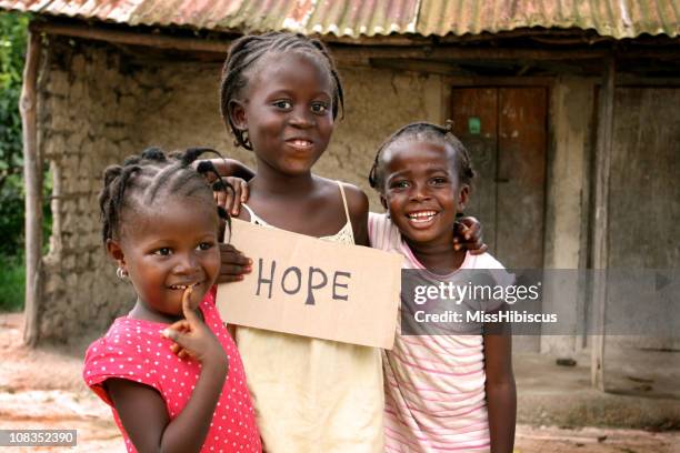 african girls with hope sign - liberian culture stock pictures, royalty-free photos & images