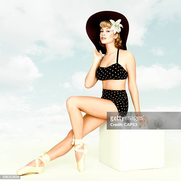 vintage pin-up girl sitting on a cube with sky background - pin up girl stock pictures, royalty-free photos & images