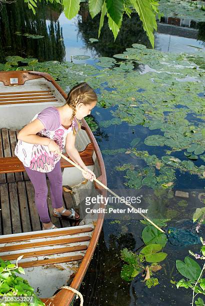 young girl fishing with net - lily platt stock pictures, royalty-free photos & images