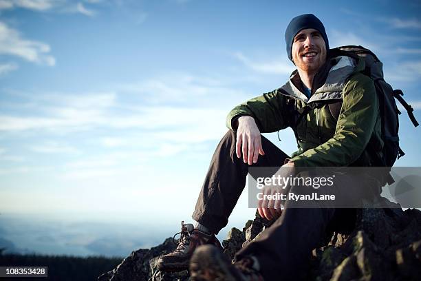 young hiker at mountain top - windbreak stock pictures, royalty-free photos & images