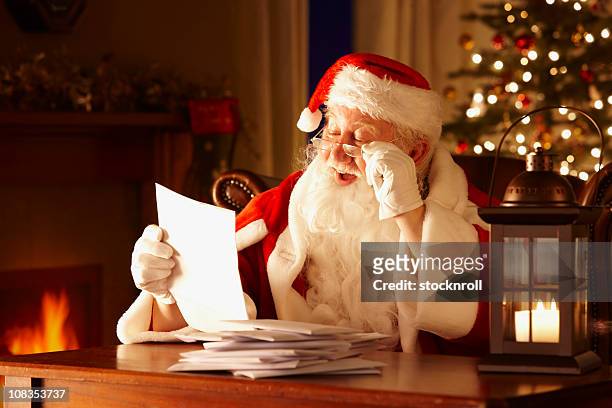 jolly father christmas reading letters from children - message stock pictures, royalty-free photos & images