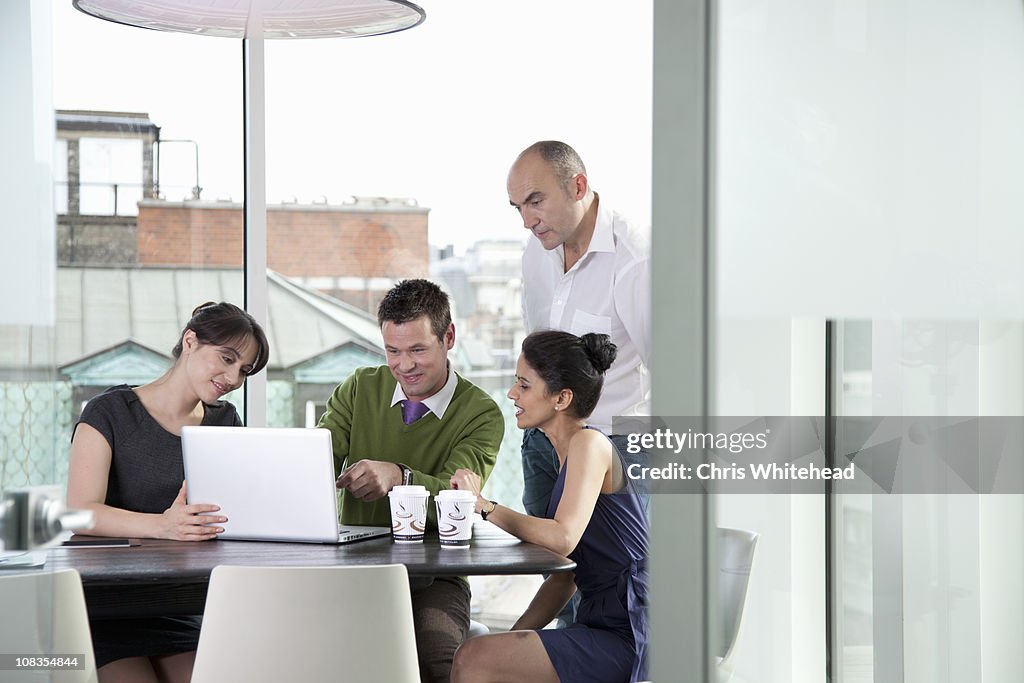 Colleagues looking at laptop