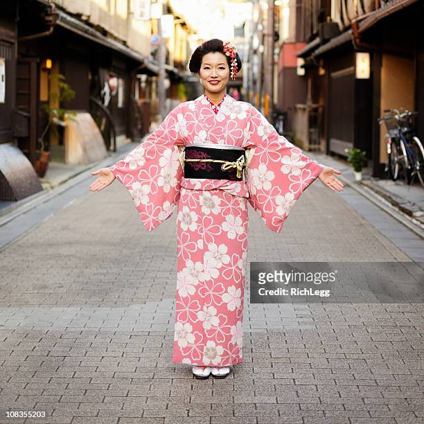 japanese woman with open arms - kimono stock pictures, royalty-free photos & images
