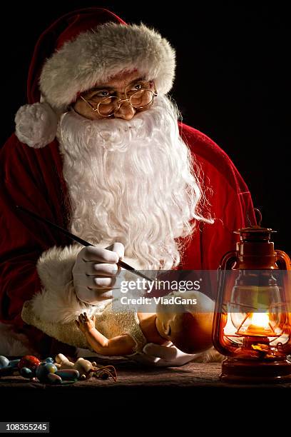 santa claus painting a toy - santas workshop stock pictures, royalty-free photos & images