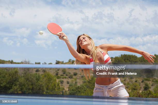 woman in a game of table tennis outdoors - women's table tennis stock-fotos und bilder