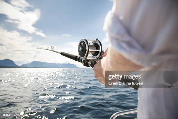 man fishing in sea - fishing rod stock-fotos und bilder