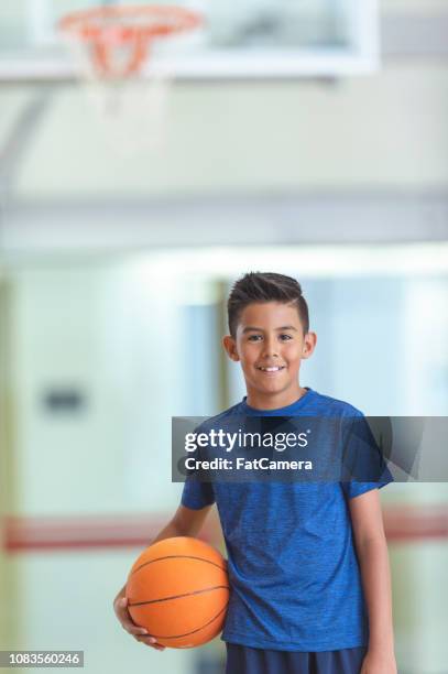 boy holding a basketball - ymca stock pictures, royalty-free photos & images