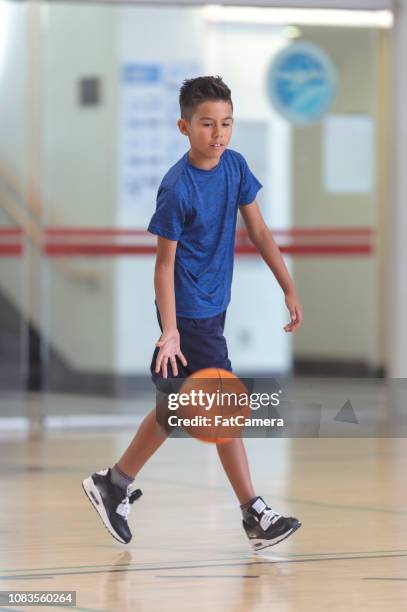 boy playing basketball - canada basketball stock pictures, royalty-free photos & images