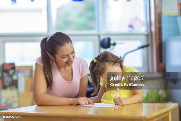 teacher with young girl - school caretaker stock pictures, royalty-free photos & images
