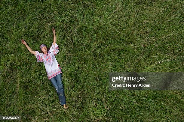 Hippy Female Relaxing In Field High-Res Stock Photo