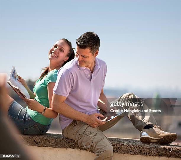 woman and man sitting on wall - daily life in zagreb stock pictures, royalty-free photos & images