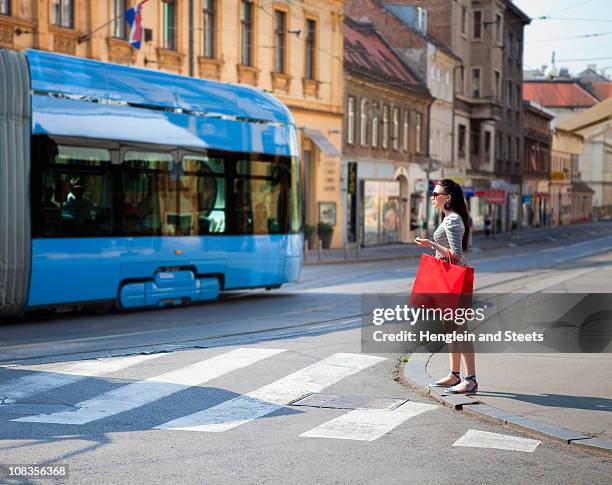 young woman crossing road - zagreb tram stock pictures, royalty-free photos & images