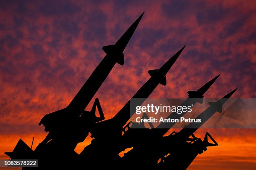 Four rockets of anti-aircraft missile system are directed upwards against the background of sunset Four rockets of anti-aircraft missile system are directed upwards against the background of sunset