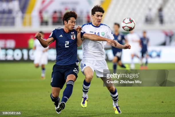 Miura Genta of Japan competes for the ball with Eldor Shomurodov of Uzbekistan during the AFC Asian Cup Group F match between Japan and Uzbekistsn at...