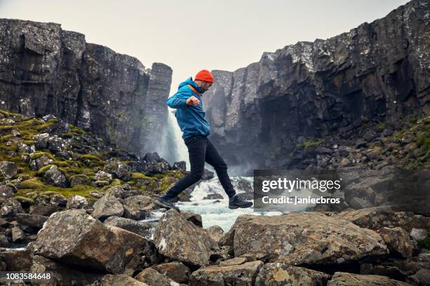 crossing the stream. mountain landscape - hiking boot stock pictures, royalty-free photos & images