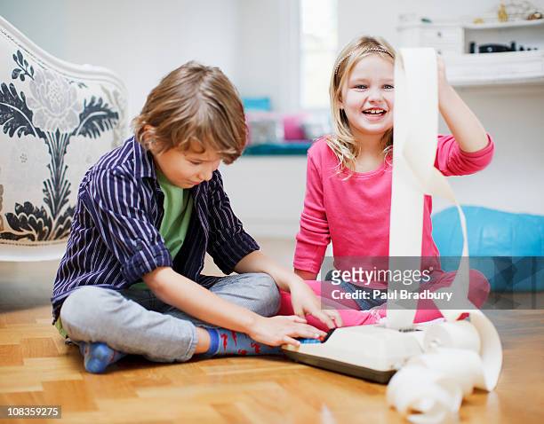 brother and sister playing with adding machine and adding machine tape - adding machine tape stock pictures, royalty-free photos & images
