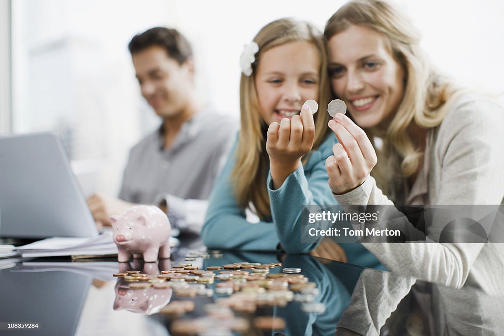 Mother and daughter comparing coins