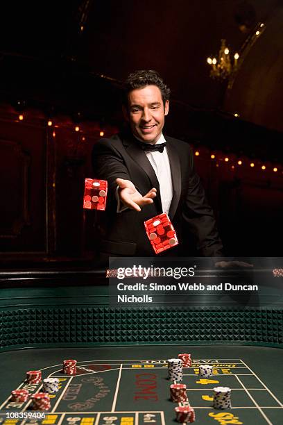 man throwing dice at craps table - ace stock pictures, royalty-free photos & images