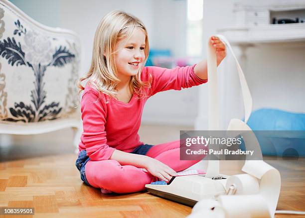 girl looking at adding machine tape - adding machine tape stock pictures, royalty-free photos & images