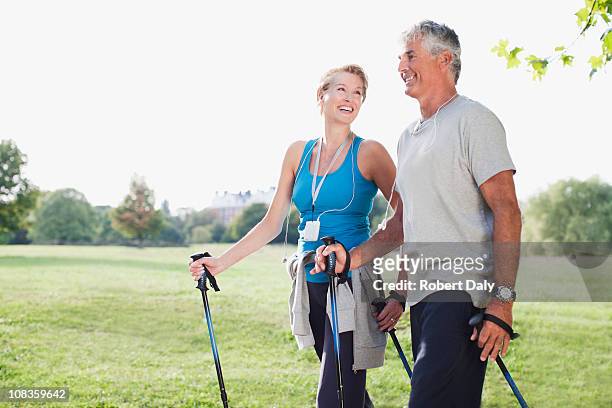 smiling couple hiking together - 50 54 years stock pictures, royalty-free photos & images