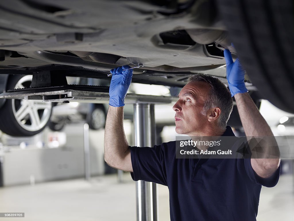 Mechanic working underneath car