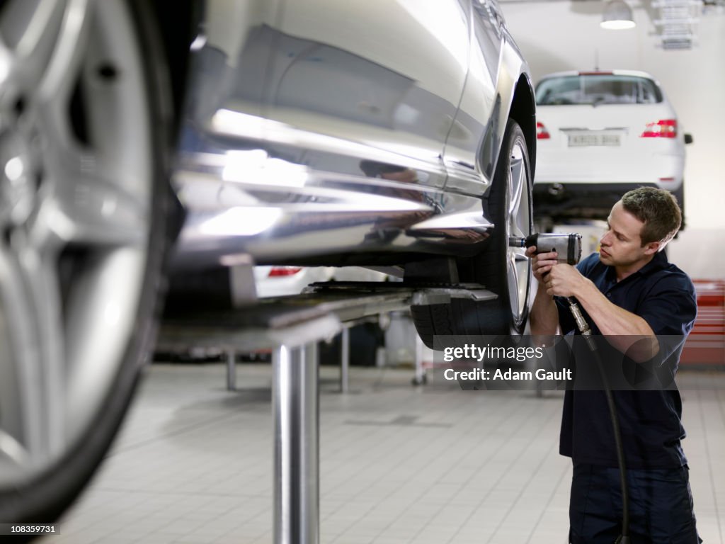 Mechanic working on car in auto repair shop