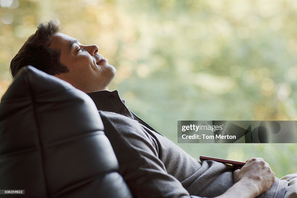 Tranquil man napping in chair