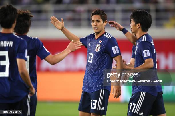 Yoshinori Muto of Japan celebrates scoring a goal to make it 1-1 during the AFC Asian Cup Group F match between Japan and Uzbekistsn at Khalifa Bin...