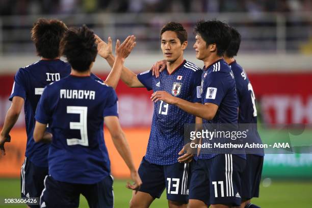 Yoshinori Muto of Japan celebrates scoring a goal to make it 1-1 during the AFC Asian Cup Group F match between Japan and Uzbekistsn at Khalifa Bin...