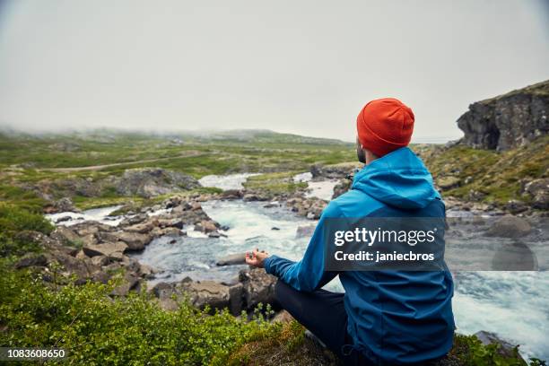 man meditation. high mountains range. waterfall - mountain ridge stock pictures, royalty-free photos & images