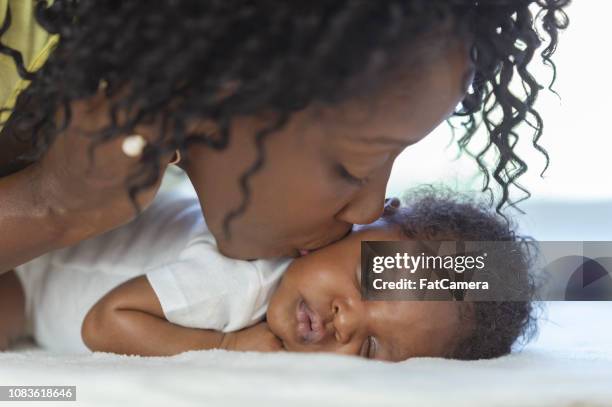 kissing newborn boy - mom resting stock pictures, royalty-free photos & images